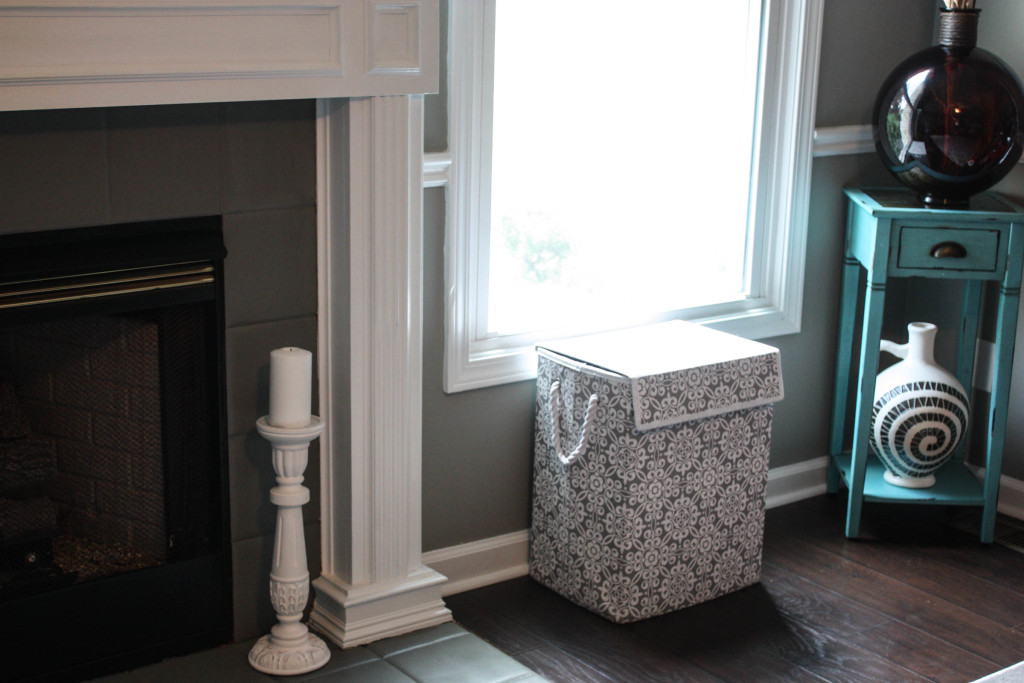 Painted fireplace with laundry basket that provides storage for toys.