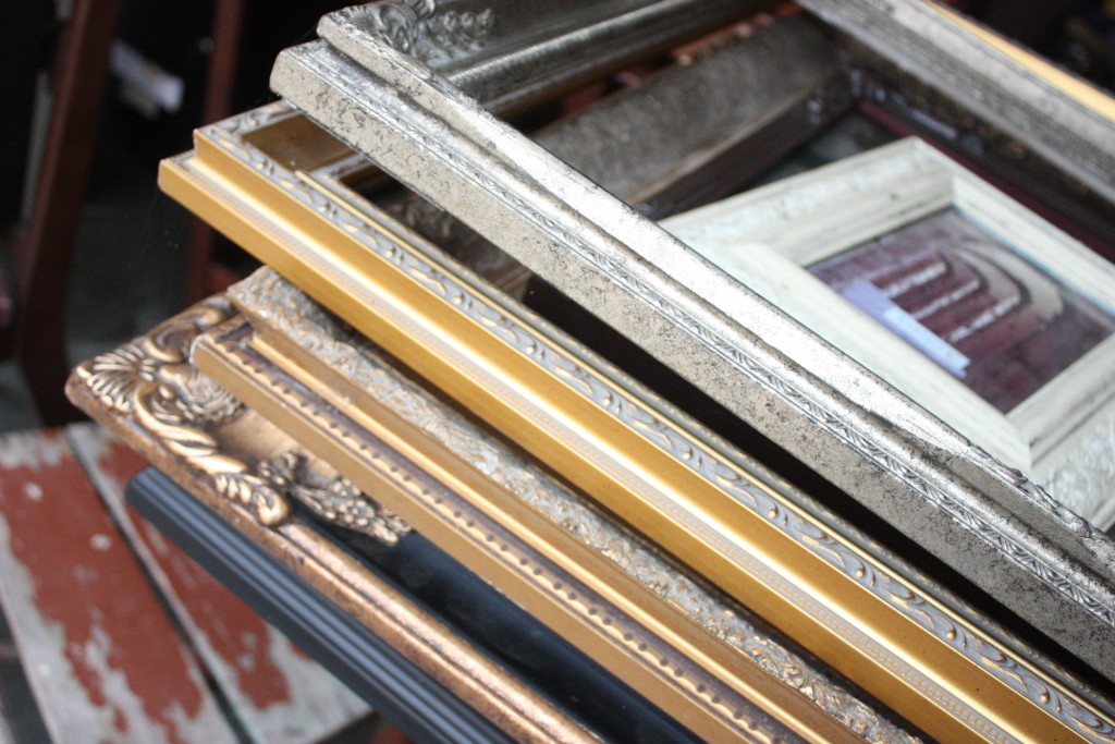 Large stack of old and new picture frames of all sizes.