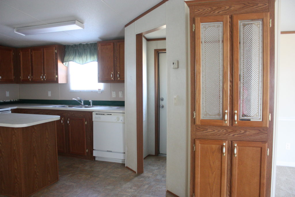 This mobile home kitchen needed major updating, and boy did it get it! Check out the post for the cabinet makeover - and how the backsplash was only $40!