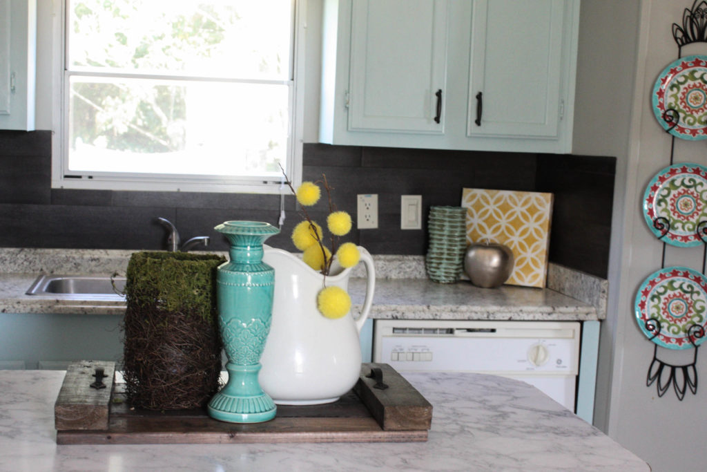 Great idea for using vinyl flooring as a kitchen backsplash!