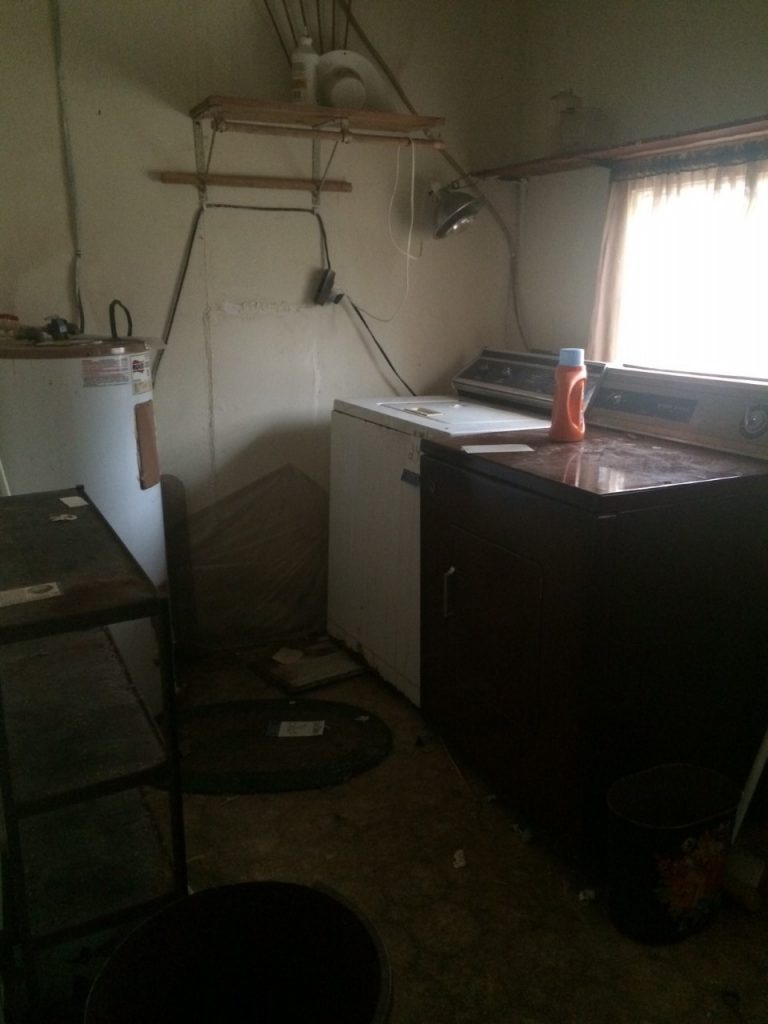 fixer upper house before picture-laundry room