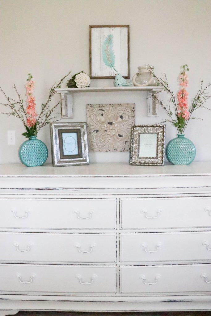 Amazing transformation of a dark and dreary master bedroom into an aqua & coral master bedroom retreat!