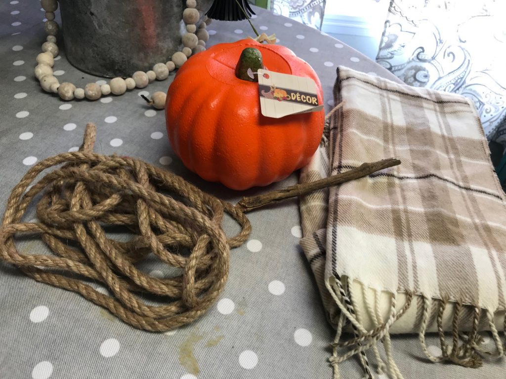 Make a super easy pumpkin with just a scarf, some sticks and a foam pumpkin!