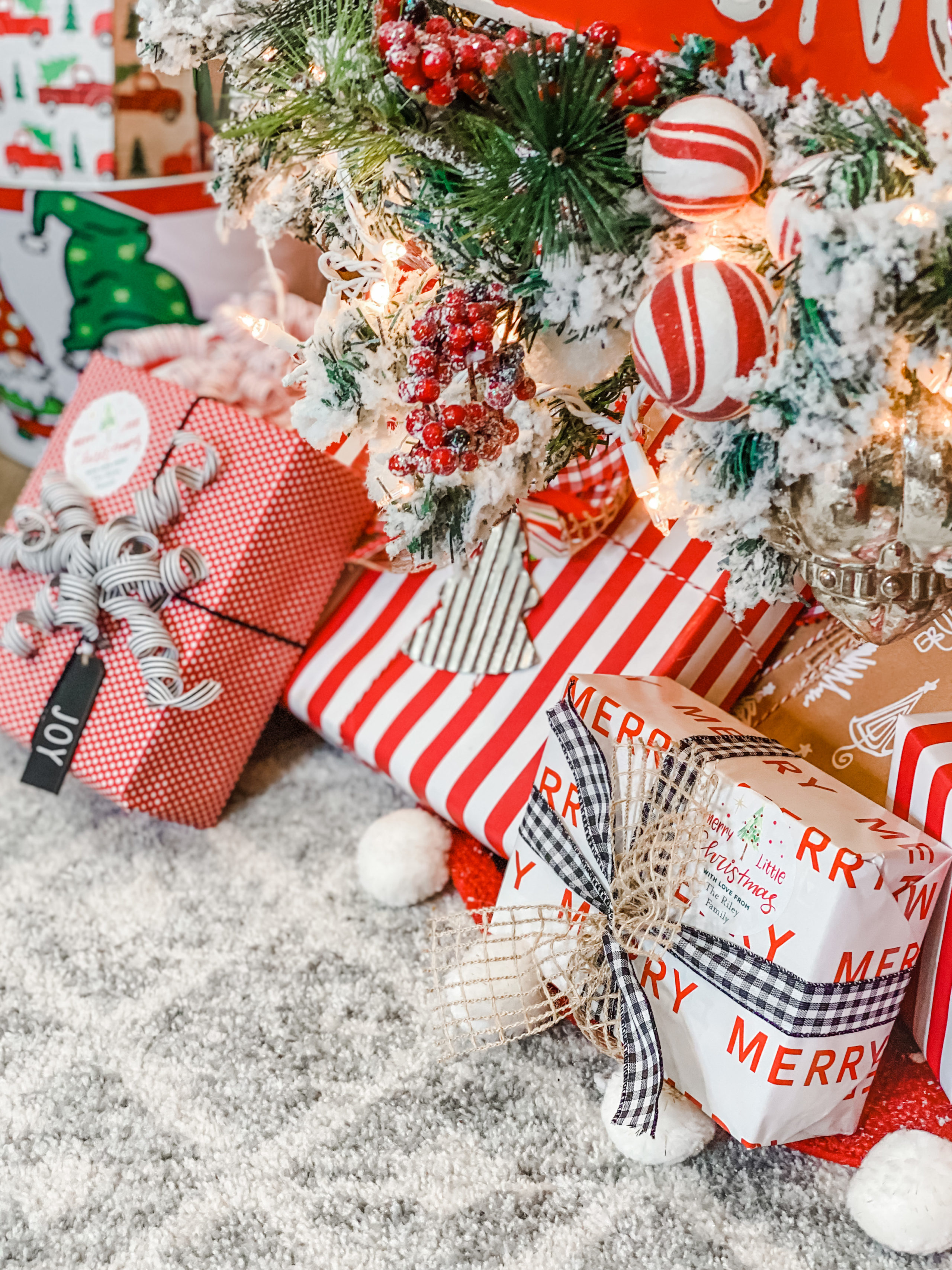 Accessories for packaging Christmas gift ,fir tree branch with red,  wrapping paper, roll of Red and white thread , christmas candy and  different wrap presents. Stock Photo