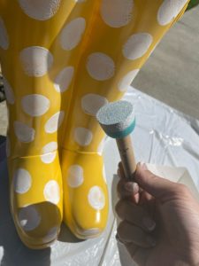 yellow rubber boot flower planter from big lots painting on white polka dots