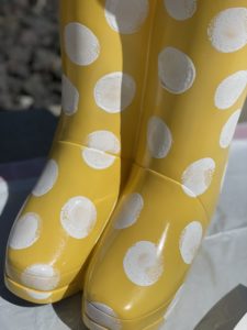 yellow rubber boot flower planter from big lots painting on white polka dots