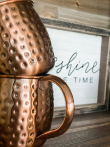 hobby lobby coffee bar sign with golden mugs on coffee bar