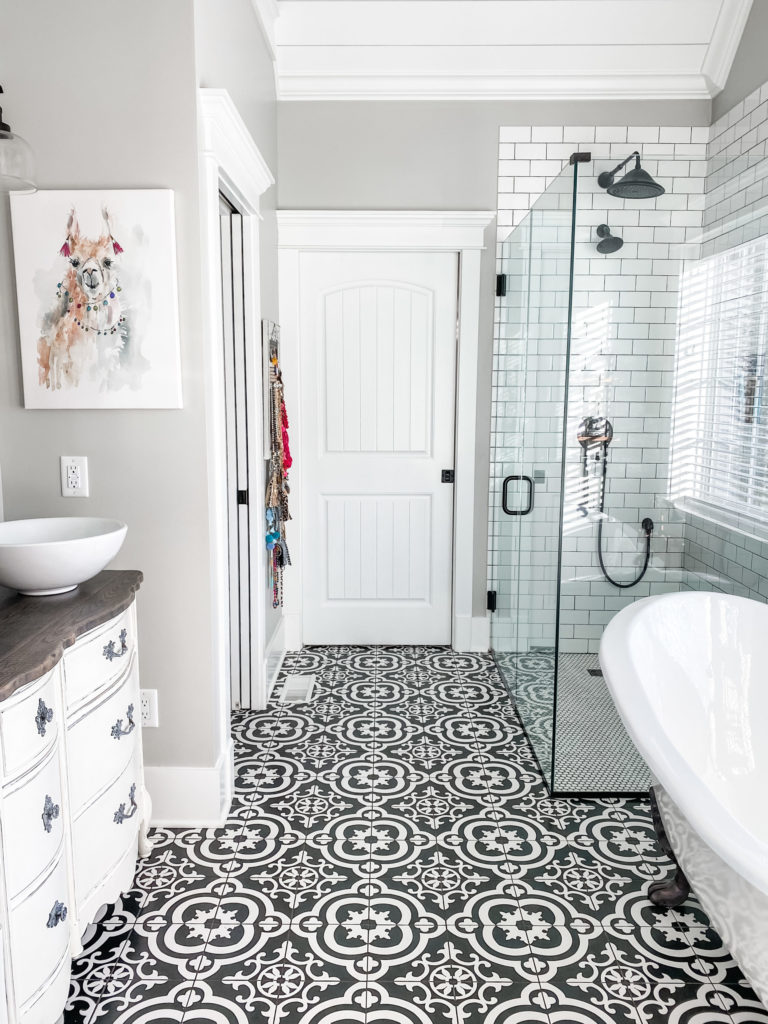 full view of master bathroom and black and white flooring