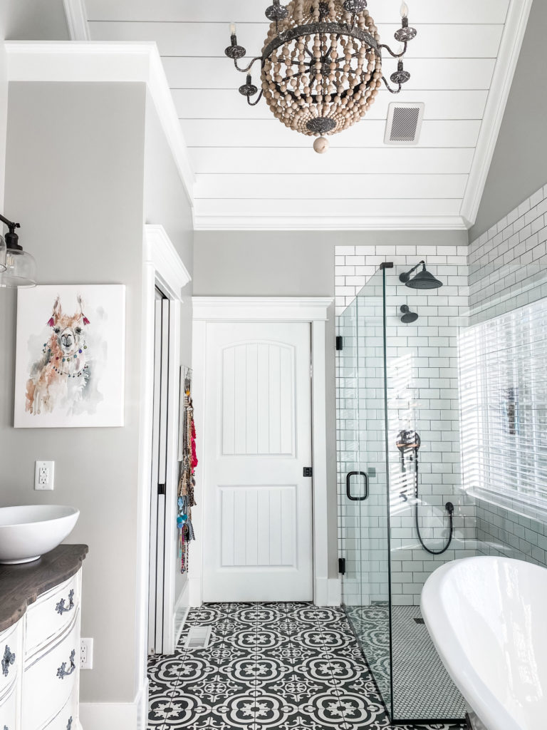 master bathroom view with beaded light fixture