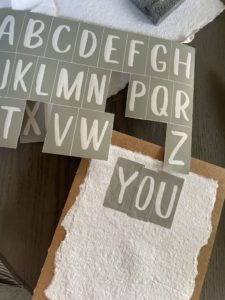 stenciling the paint onto the watercolor paper