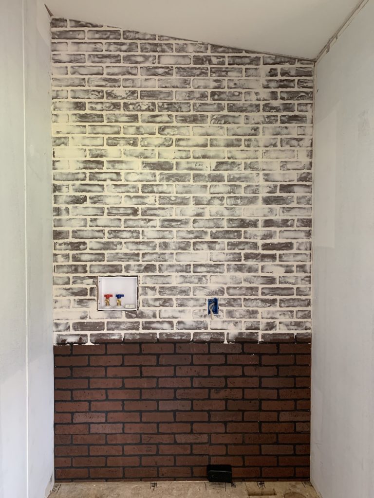 laundry room in a mobile home in process of installing brick board to german smear