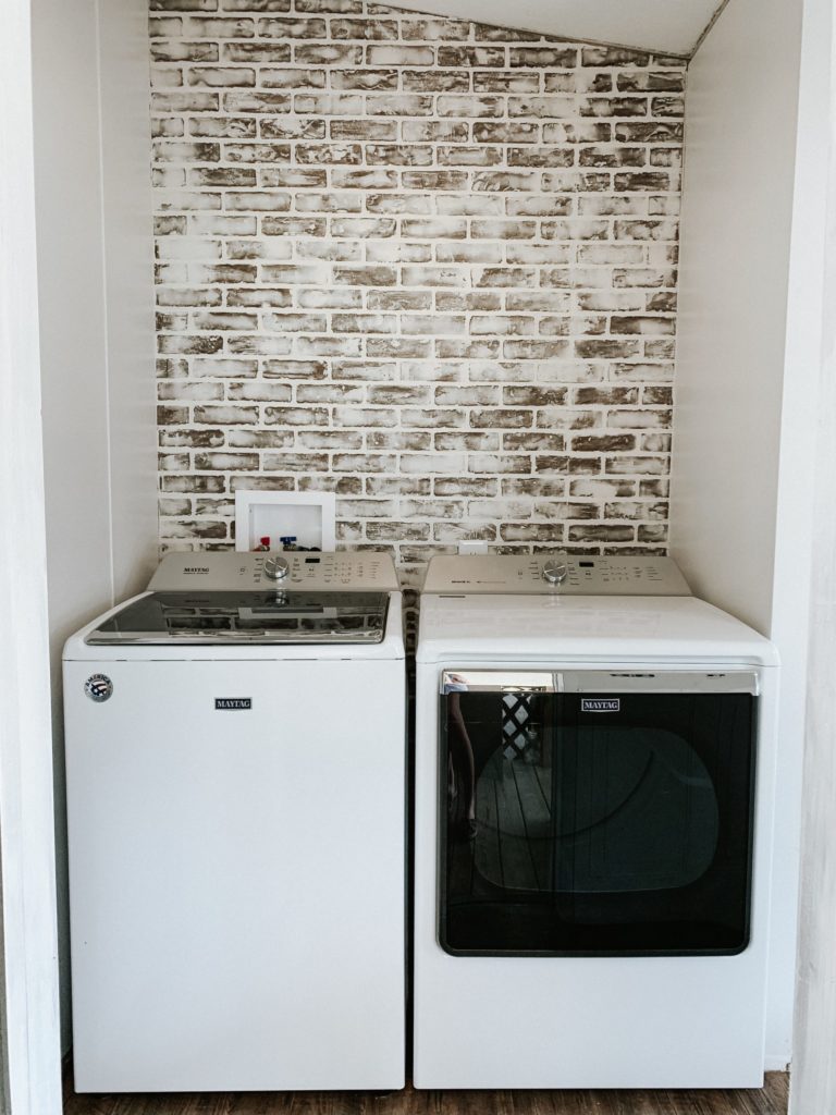 laundry room in a mobile home in process of installing brick board to german smear