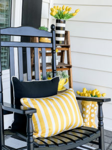 home sign on front porch with rocking chair