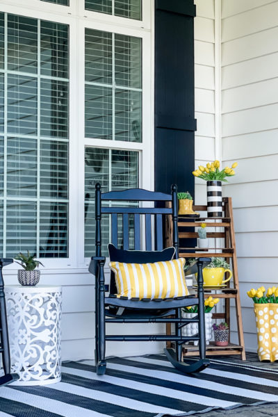 rocking chairs with yellow decor on modern spring front porch