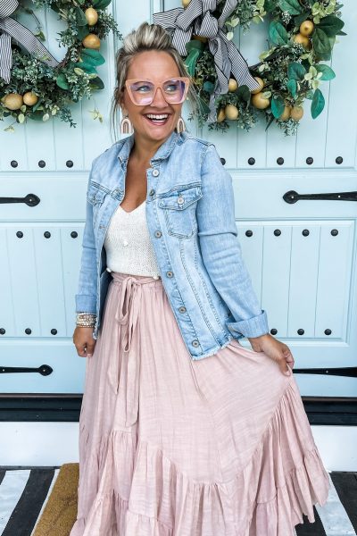 Brooke Riley standing in front off double doors with wreaths.