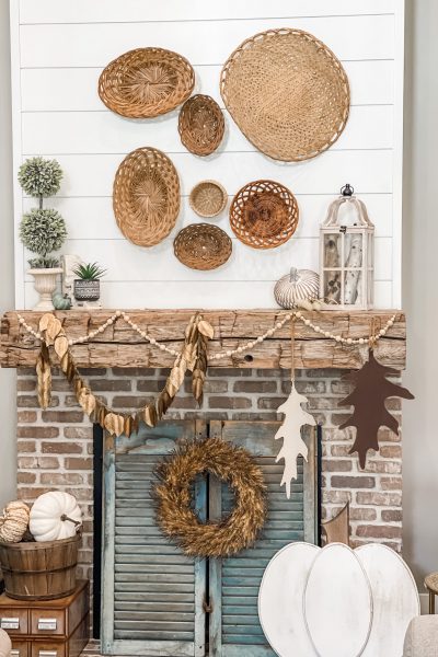 view of fall mantel decorated with baskets and neutral elements