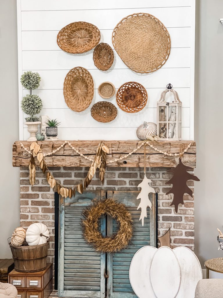 view of fall mantel decorated with baskets and neutral elements