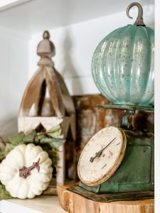 close up of vintage scale with glass pumpkin on top