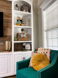 full image of 8 built in shelving units around TV styled for fall