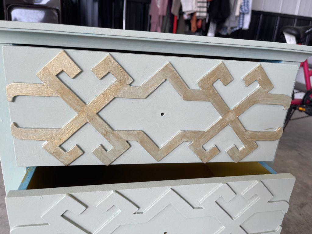 brush on the gold paint to the high points of the table