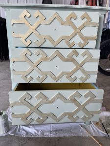 paint the gold paint onto the high points of the table