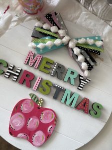 hot glue your letters, apple, and bow onto door hanger