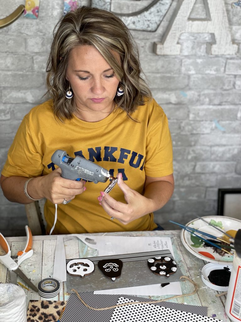 hot glue your jack o lanterns to the galvanized sign