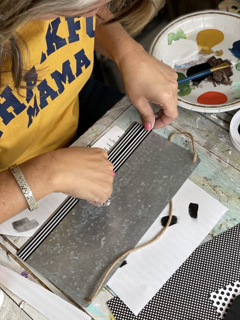 add black and white washi tape to the bottom of the galvanized sign