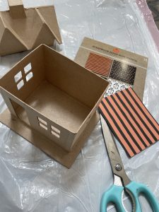 cut scrapbook paper to fit inside of house