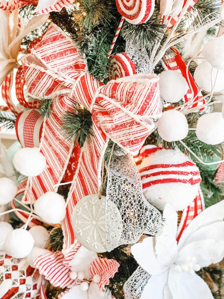 red and white christmas bow on tree