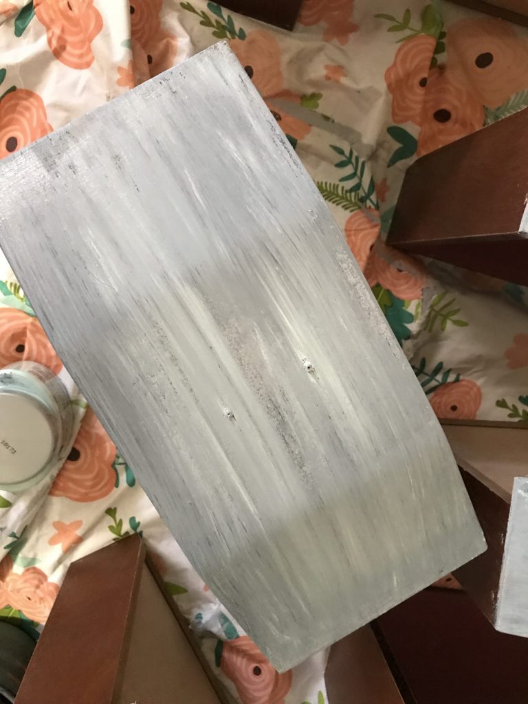 another layer of gray paint on wooden drawer