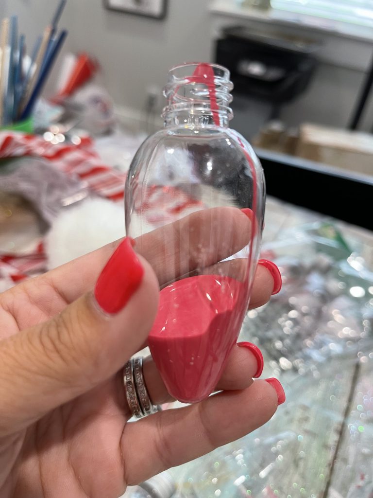 plastic bulb ornament with paint in bottom