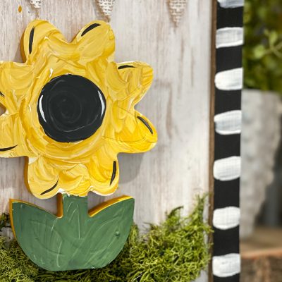 painted sunflower sign with burlap banner